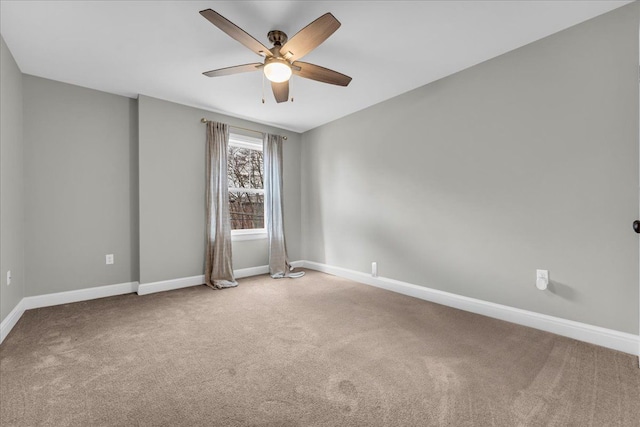 empty room with carpet floors, ceiling fan, and baseboards