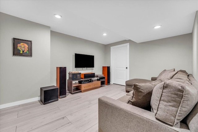 living area with recessed lighting, light wood-style flooring, and baseboards