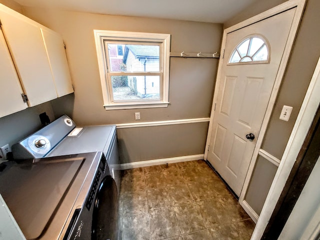 laundry area with washer and clothes dryer, tile patterned flooring, cabinet space, and baseboards