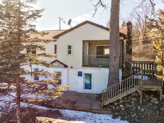 back of property featuring a patio area, stairs, and a chimney