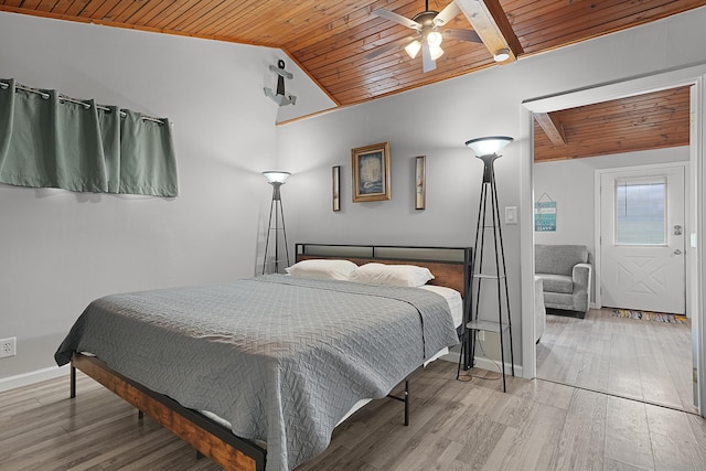 bedroom with lofted ceiling with beams, ceiling fan, wood finished floors, wooden ceiling, and baseboards