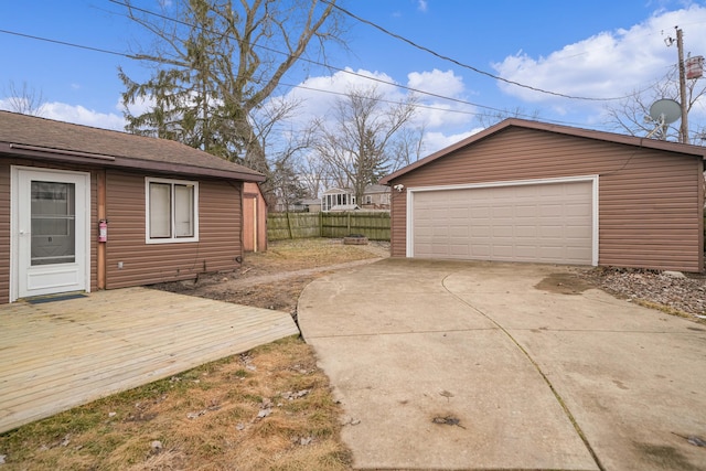 detached garage featuring fence