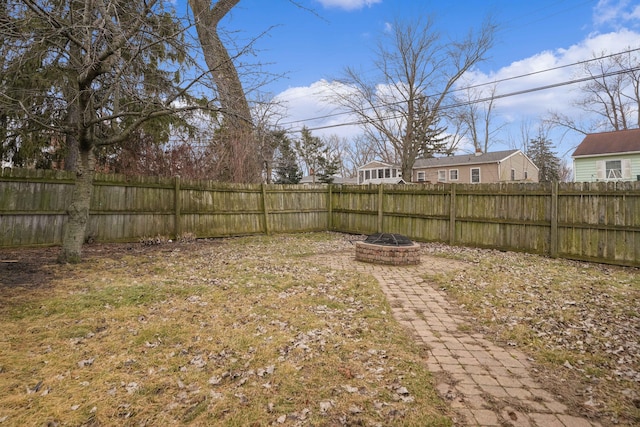 view of yard with a fire pit and fence private yard