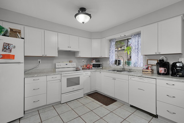 kitchen featuring white appliances, under cabinet range hood, light countertops, and a sink