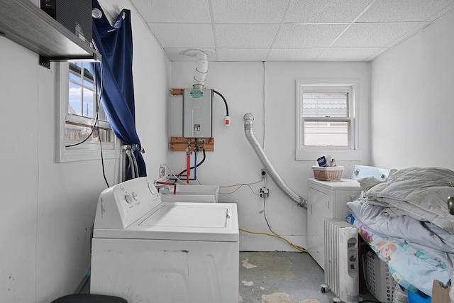 laundry area featuring laundry area, water heater, and washer and clothes dryer