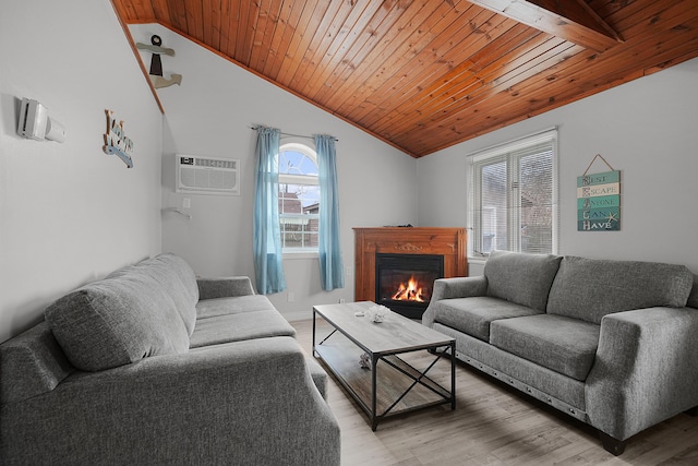 living room with a wall unit AC, light wood finished floors, a glass covered fireplace, vaulted ceiling, and wooden ceiling