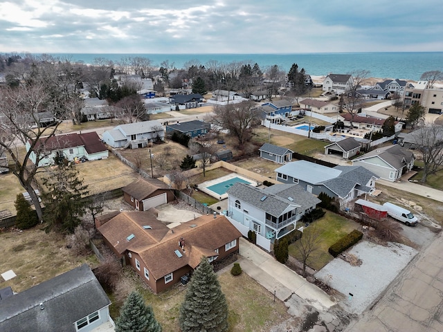 drone / aerial view with a water view and a residential view