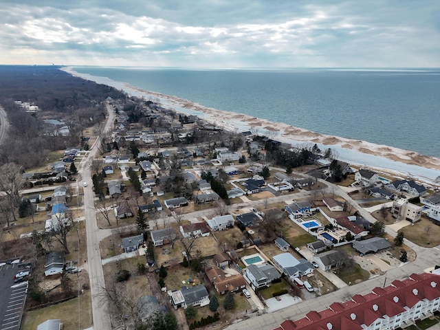 aerial view featuring a water view, a view of the beach, and a residential view