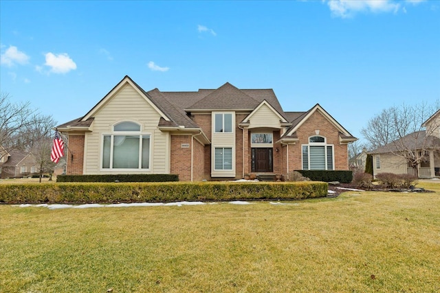 traditional home featuring brick siding and a front lawn