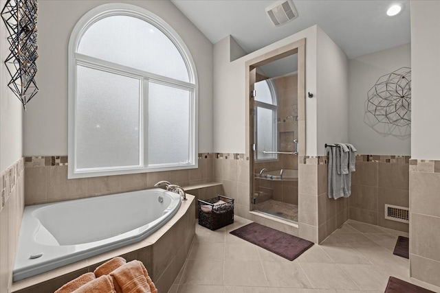 full bath featuring a shower stall, visible vents, a bath, and tile patterned floors