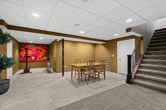 dining space featuring recessed lighting, a drop ceiling, stairway, and tile patterned floors