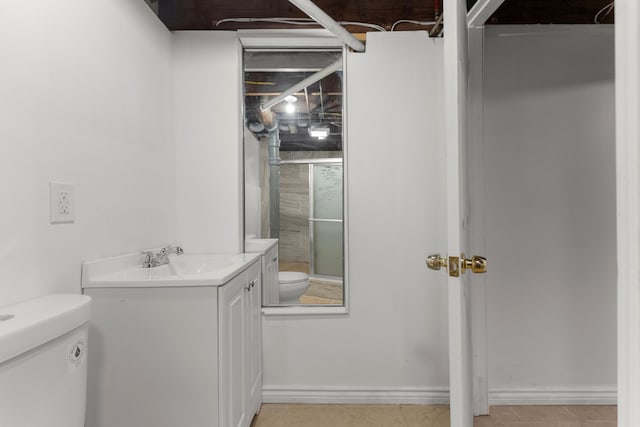 full bath with a stall shower, vanity, and toilet