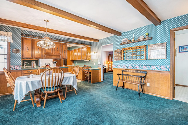 dining space with dark colored carpet, beamed ceiling, and wallpapered walls