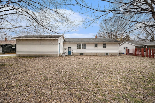 rear view of house with fence