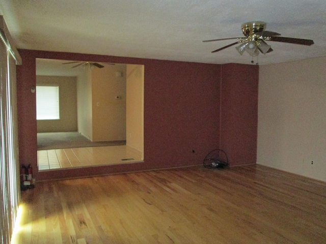 spare room featuring a ceiling fan and wood finished floors