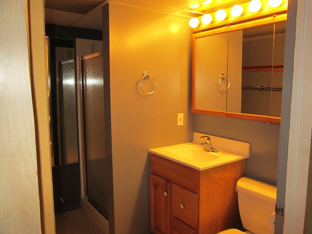 full bathroom with a stall shower, vanity, and toilet