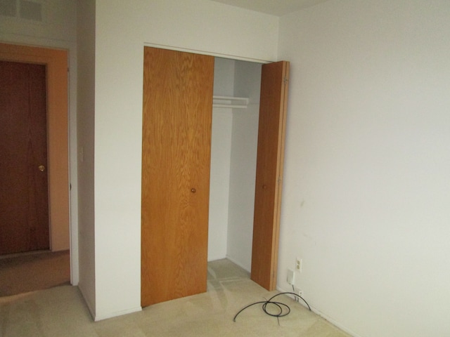 unfurnished bedroom with carpet floors and a closet