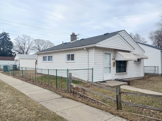 view of front of home featuring a chimney and fence