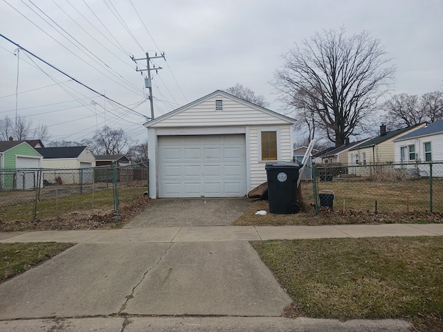 detached garage with driveway and fence