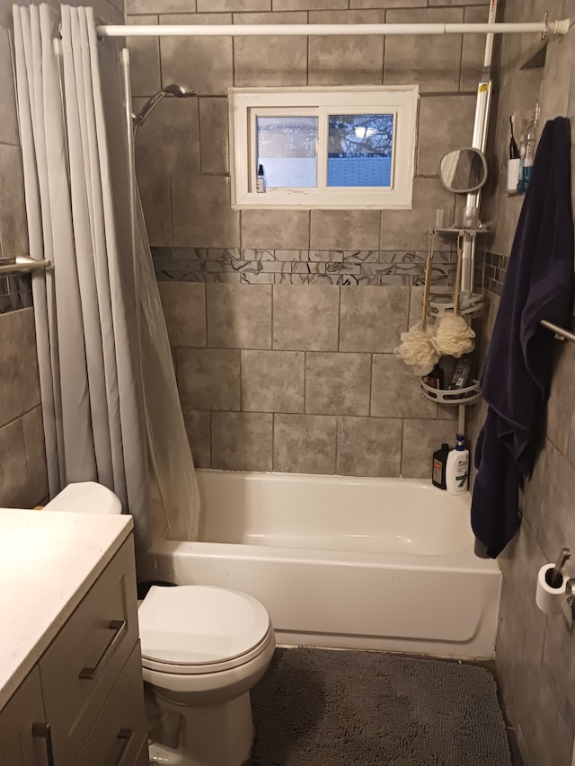 full bathroom featuring toilet, shower / bathtub combination with curtain, and vanity