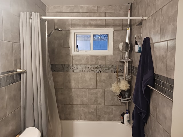 bathroom with shower / bath combo with shower curtain