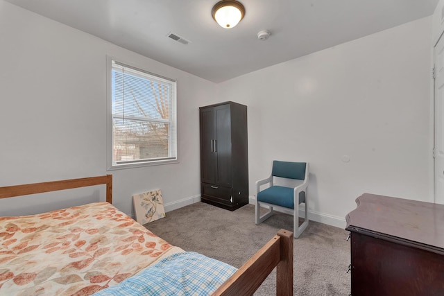 carpeted bedroom with visible vents and baseboards