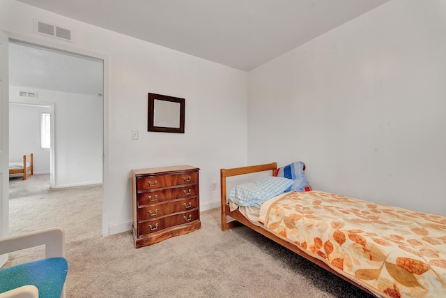 bedroom featuring baseboards, visible vents, and carpet flooring