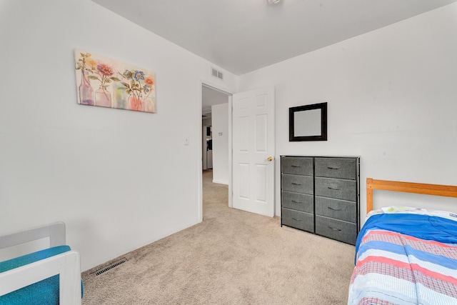 carpeted bedroom featuring visible vents