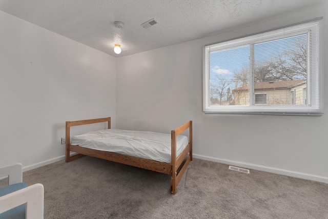 carpeted bedroom with visible vents, baseboards, and multiple windows