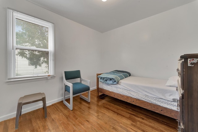 bedroom with light wood-type flooring and baseboards