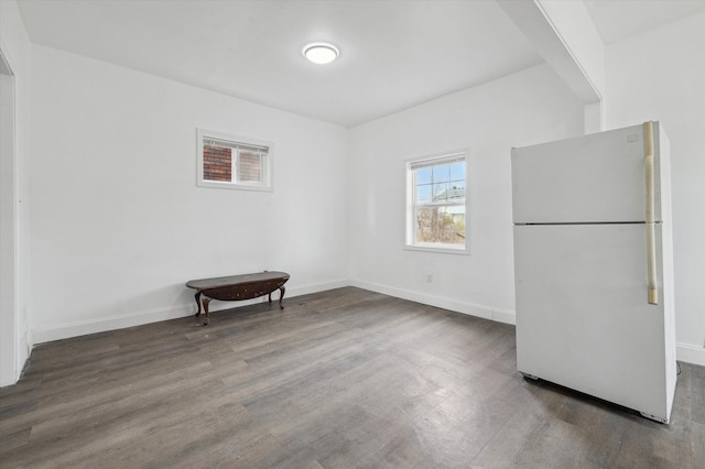 empty room with baseboards and wood finished floors