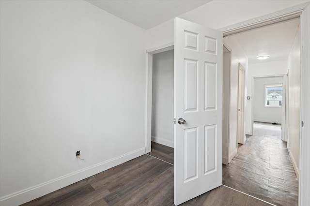 interior space with dark wood finished floors and baseboards