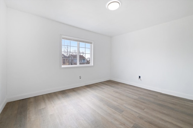 unfurnished room featuring wood finished floors and baseboards