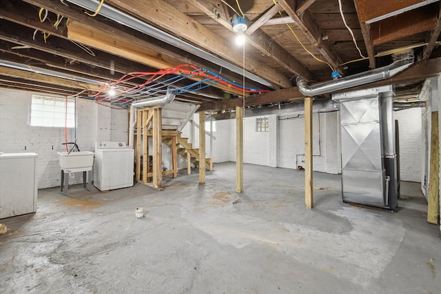 basement with washer / dryer, a sink, and heating unit