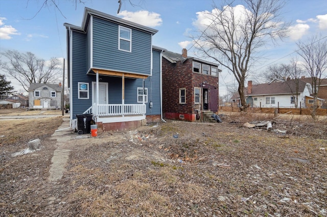 rear view of house with covered porch