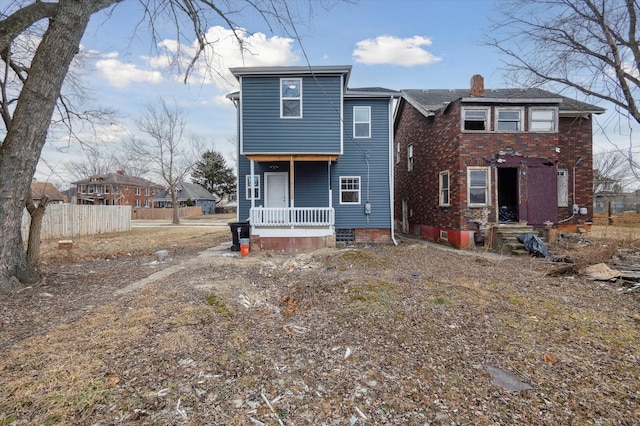 rear view of property featuring entry steps and fence