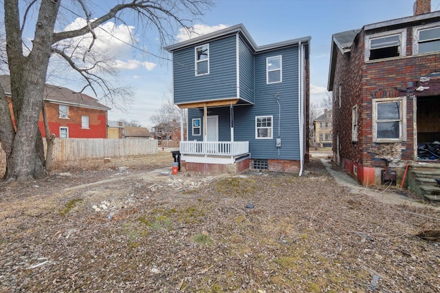 rear view of house with fence