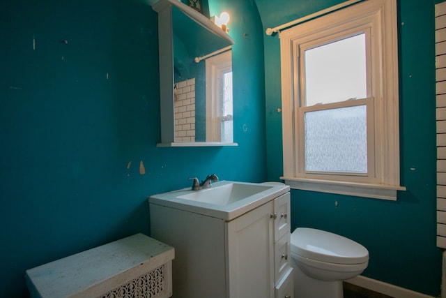 bathroom with a shower, vanity, and toilet