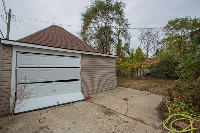 detached garage featuring driveway