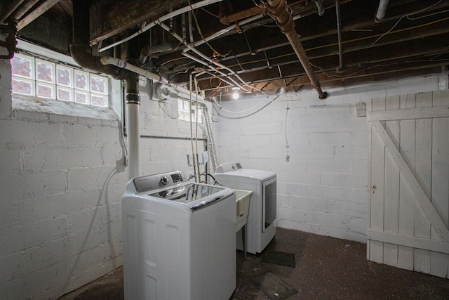 clothes washing area featuring washer and dryer and laundry area