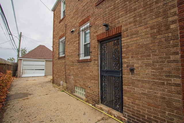 entrance to property with a garage and brick siding