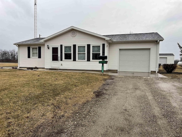 single story home with a garage, a front yard, and driveway