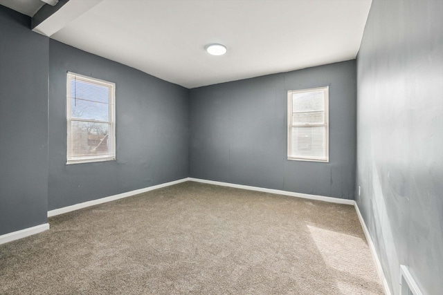 carpeted spare room with baseboards