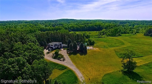 birds eye view of property with a forest view