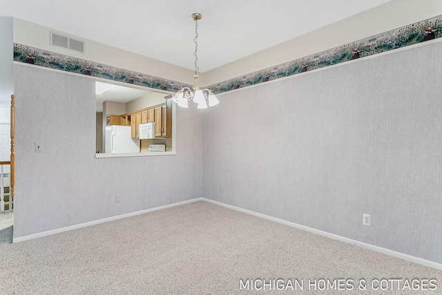 empty room with carpet floors, visible vents, baseboards, and wallpapered walls