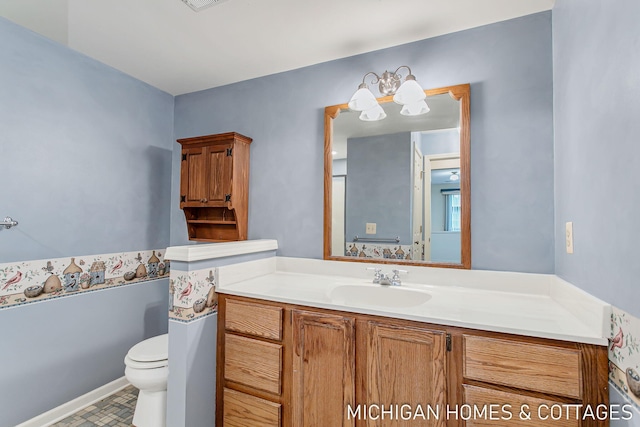 half bathroom featuring toilet, visible vents, and vanity