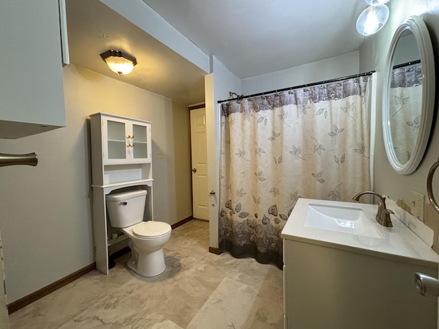 full bathroom with vanity, toilet, and baseboards