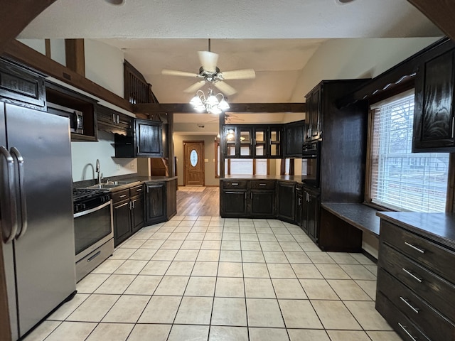 kitchen with light tile patterned floors, stainless steel appliances, lofted ceiling, a sink, and ceiling fan