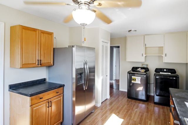 kitchen featuring dark countertops, open shelves, light wood-type flooring, stainless steel refrigerator with ice dispenser, and separate washer and dryer