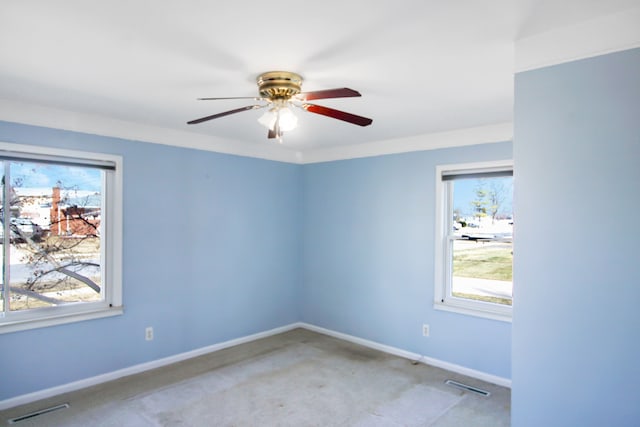 spare room featuring visible vents, ceiling fan, carpet, and baseboards